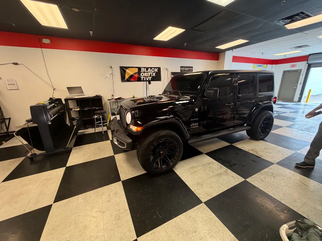 Black Jeep Wrangler with full ceramic tint at Black Optix Tint Pensacola